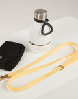 yellow dog leash, dog poop bag and dog waterbottle