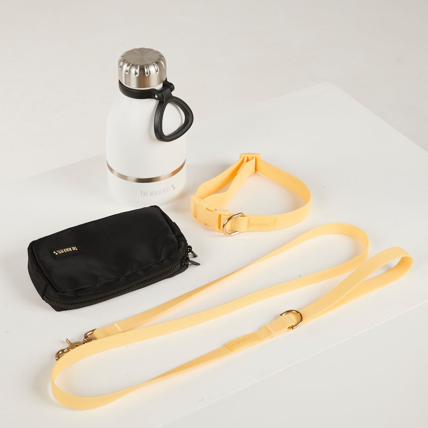 yello dog lead, dog collar, bottle and poop bag