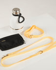 yello dog lead, dog collar, bottle and poop bag