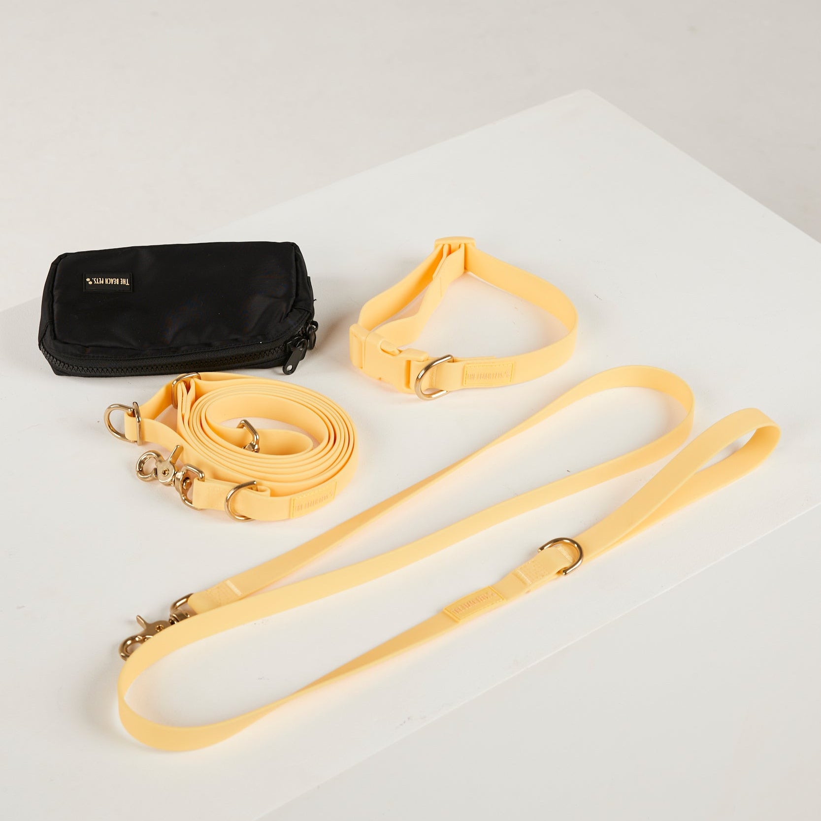 yellow dog collar, dog lead and dog poop bag pouch