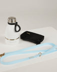 blue dog leash, dog poop bag and dog waterbottle