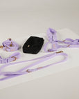 Lavender dog harness, leash, and collar set on a white surface