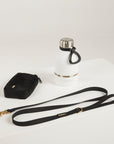 black dog leash, dog poop bag and dog waterbottle