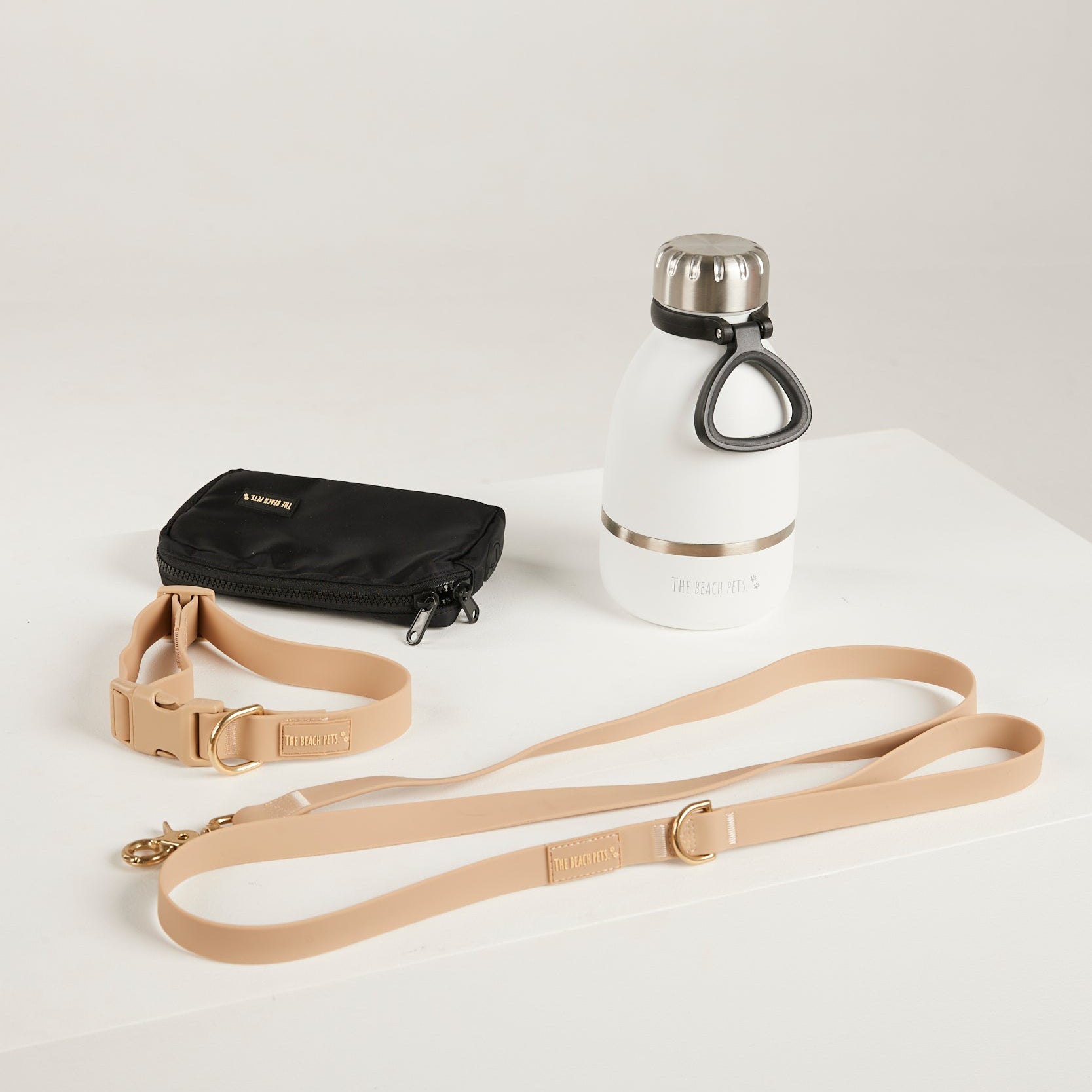 sand dog lead, dog collar, bottle and poop bag