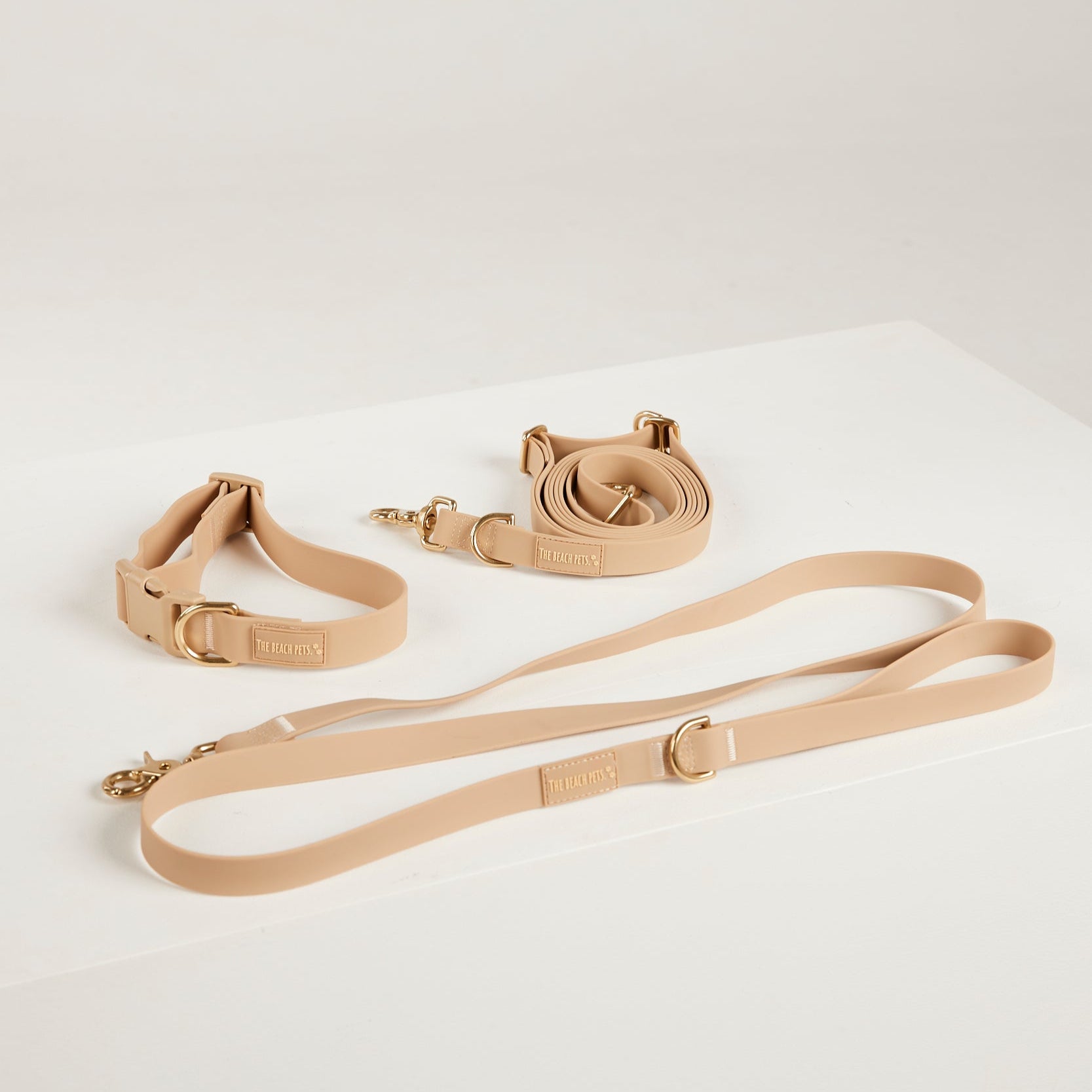 Beige dog collar and leash set on a white background