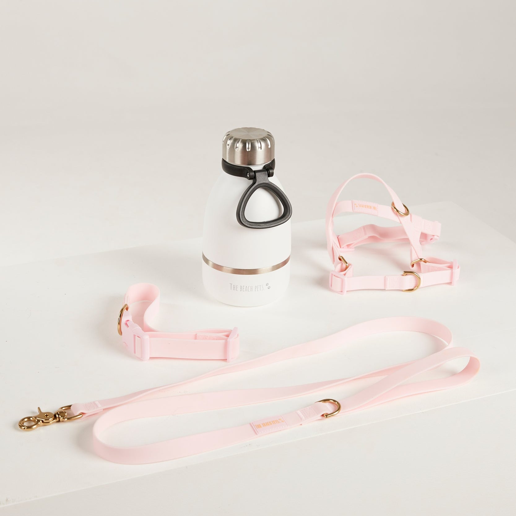 pink dog lead, harness, collar and bottle