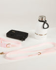 pink dog lead, dog collar, bottle and poop bag