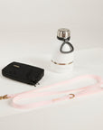 pink dog leash, dog poop bag and dog waterbottle