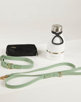 green dog lead, dog collar, bottle and poop bag