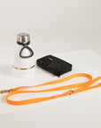 orange dog leash, dog poop bag and dog waterbottle
