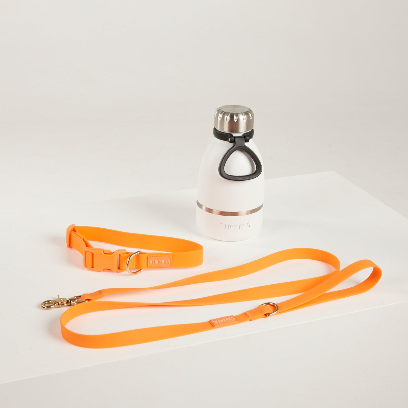 orange dog collar orange dof leash and waterbottle