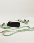 green dog collar, dog harness, dog leash and poop bag
