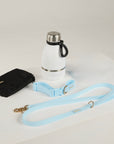blue dog lead, dog collar, bottle and poop bag