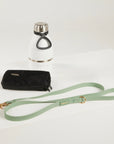 green dog leash, dog poop bag and dog waterbottle