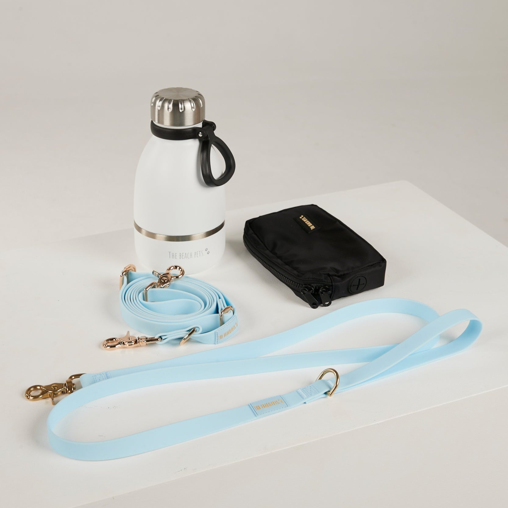 blue dog lead, hands free lead, poop bag, bottle 