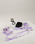 Collection of dog training equipment including a collar, leash, and other accessories on a white surface.