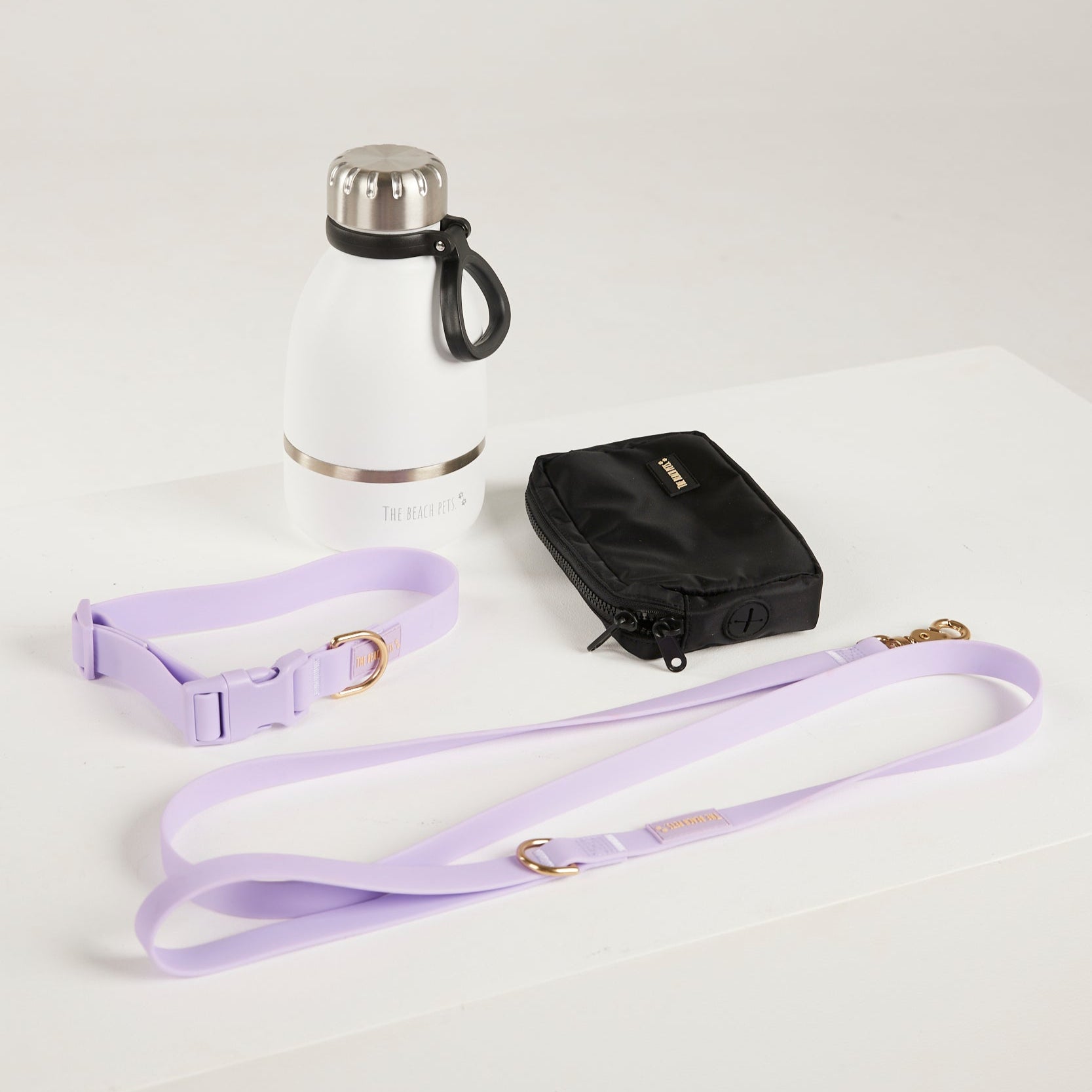 lilac dog lead, dog collar, bottle and poop bag 