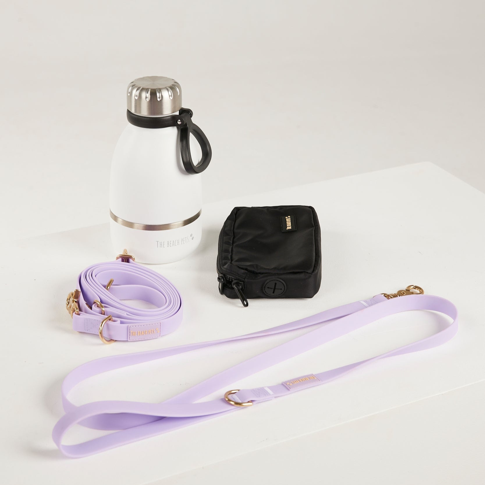 purple dog lead, hands free lead, poop bag, bottle 
