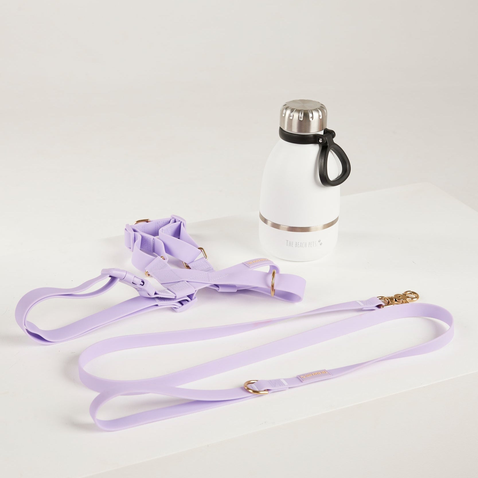 purple waterproof harness, dog lead and waterbottle