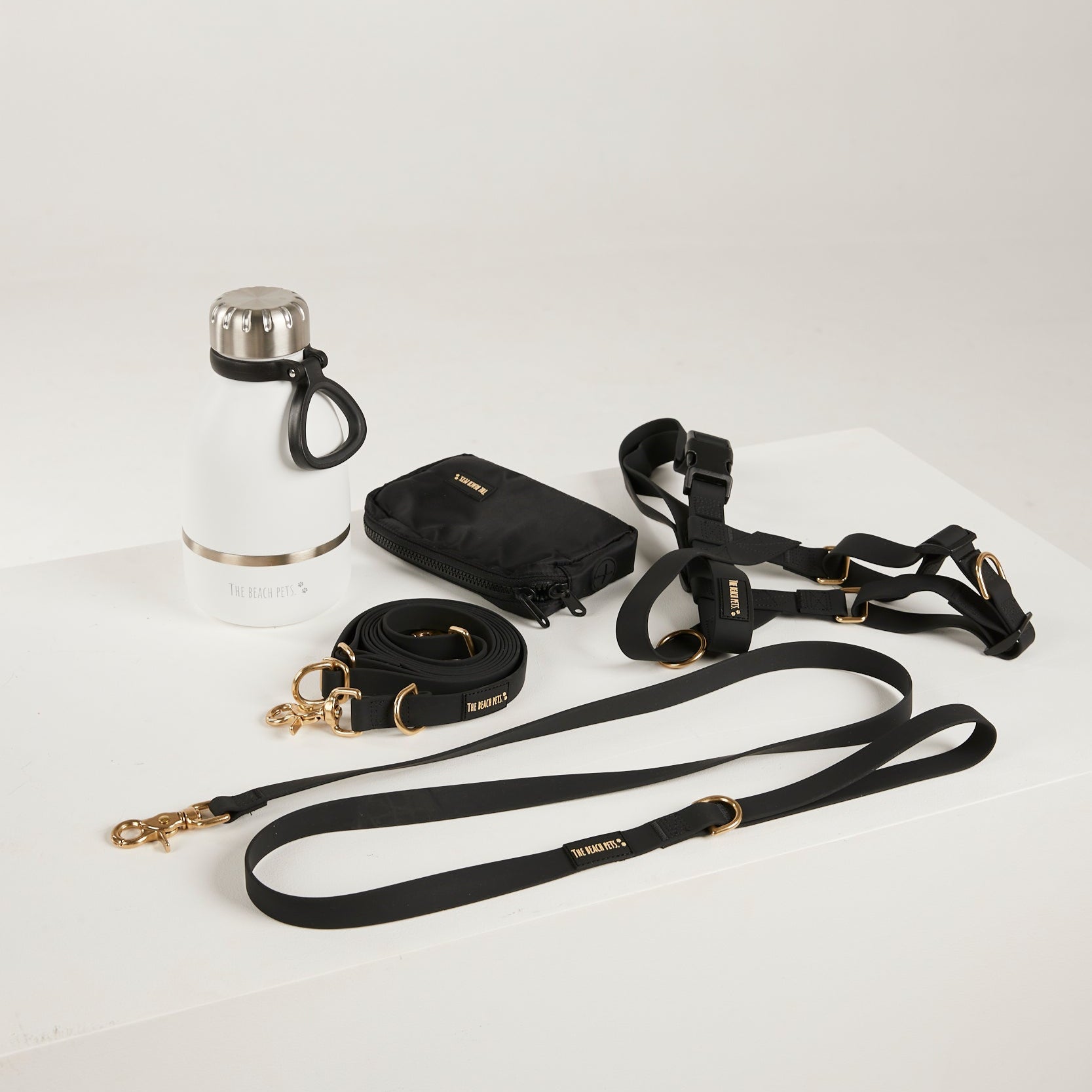 black dog lead, dog water bottle, dog harness, dog poo bag pouch 