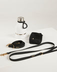 black dog lead, hands free lead, poop bag, bottle 