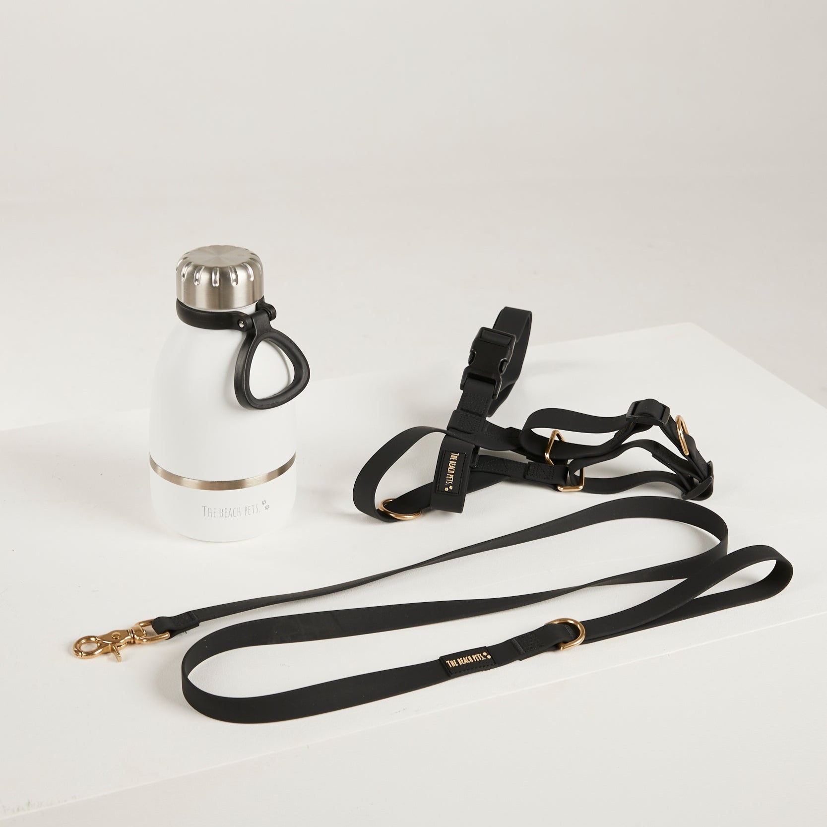 black waterproof harness, dog lead and waterbottle