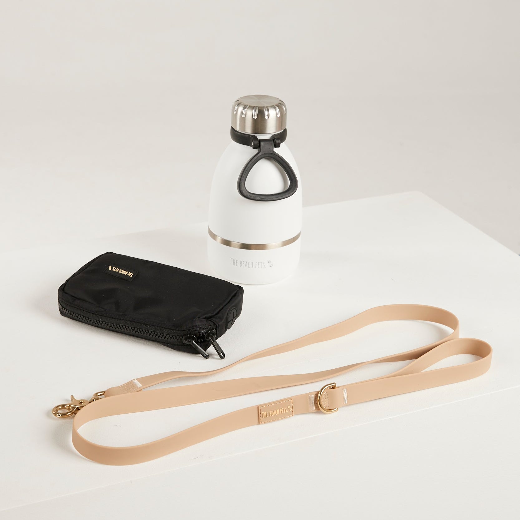 sand  dog leash, dog poop bag and dog waterbottle