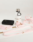 Dog collar, leash, and water bottle on a light gray background