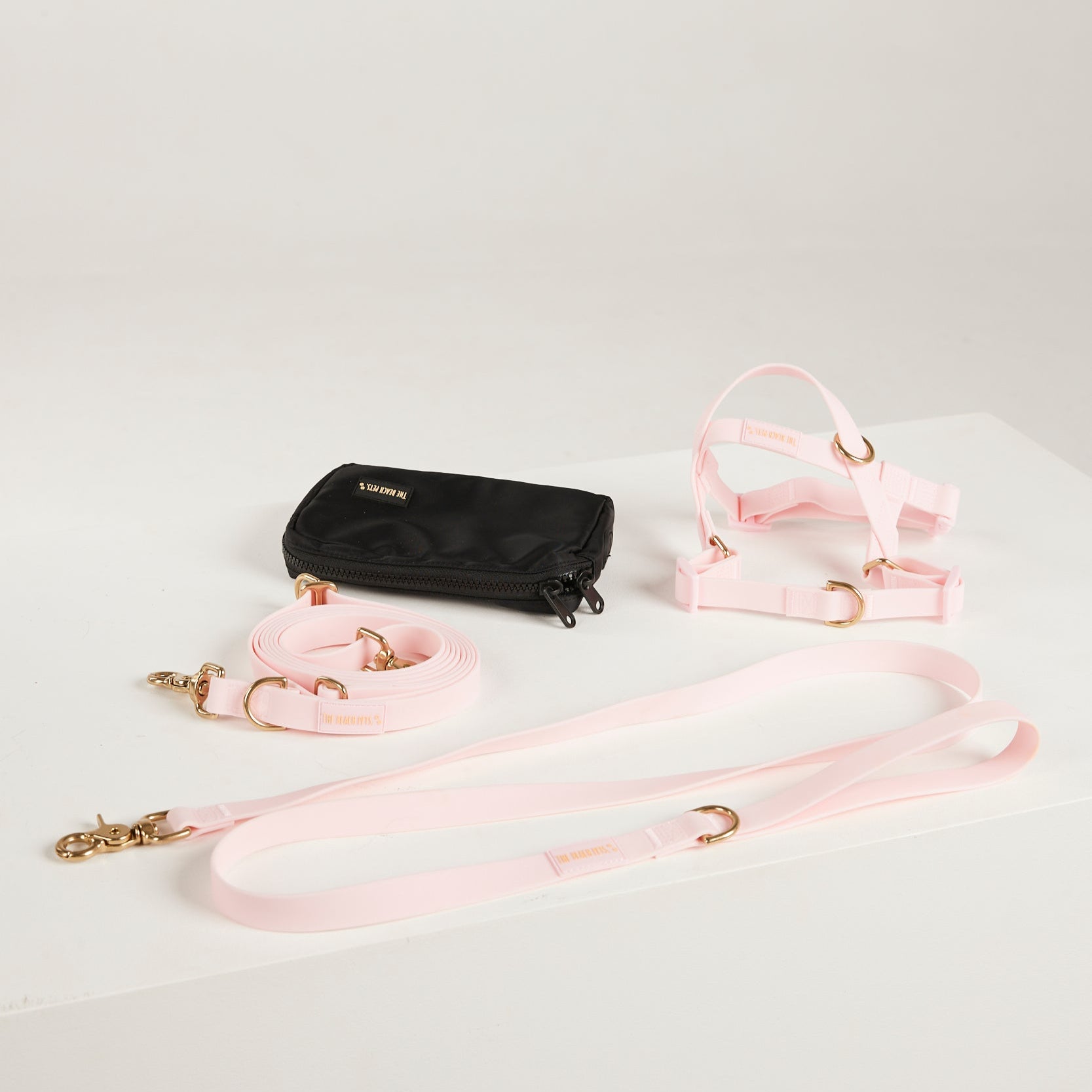 pink dog lead, harness and poop bag