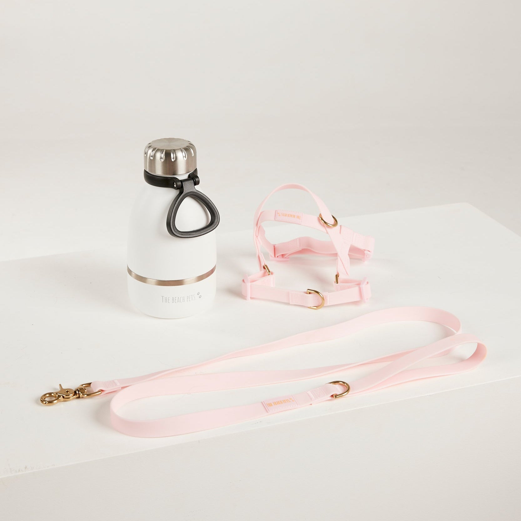 pink waterproof harness, dog lead and waterbottle