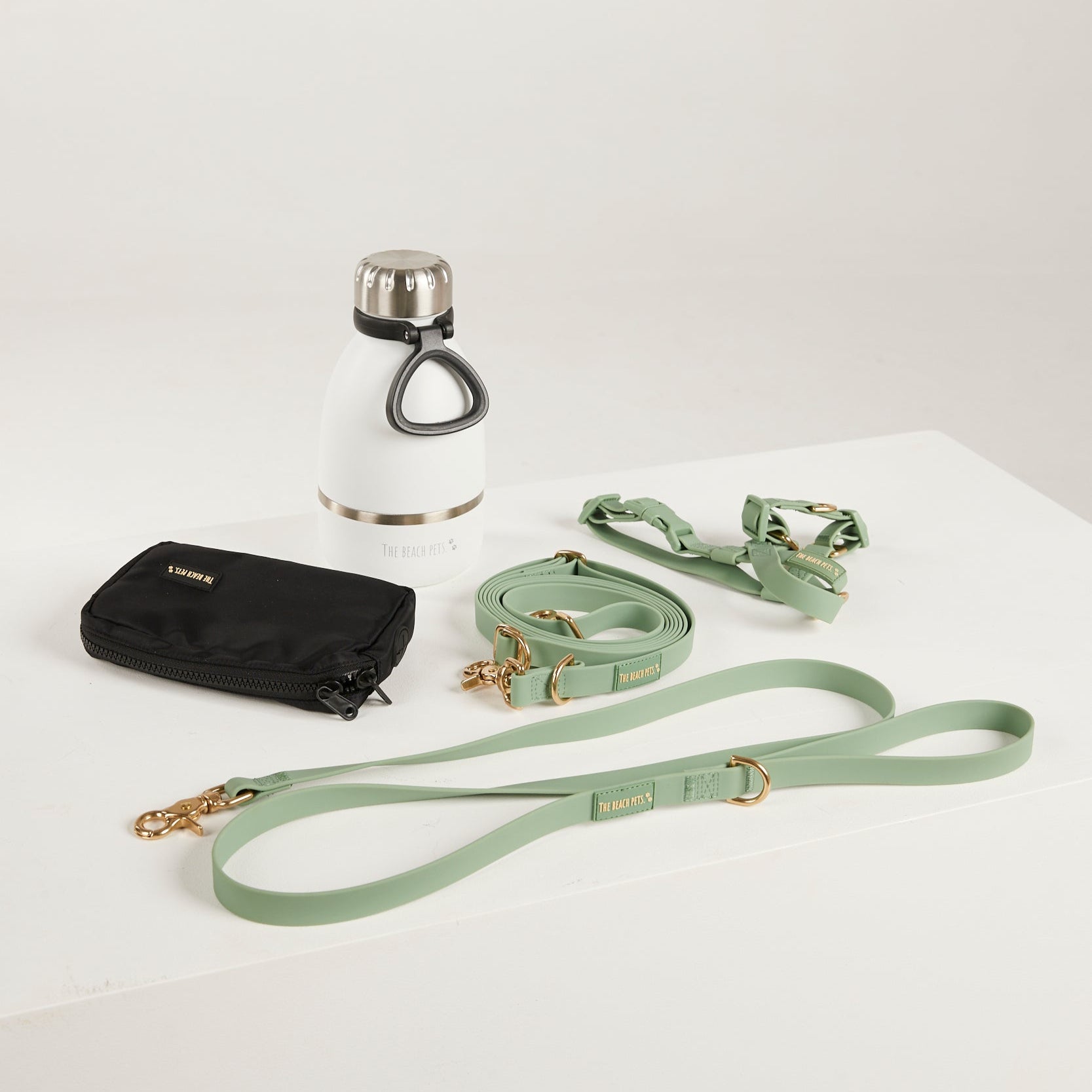 green dog lead, dog water bottle, dog harness, dog poo bag pouch 
