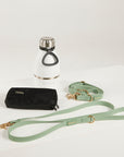 green dog lead, hands free lead, poop bag, bottle 