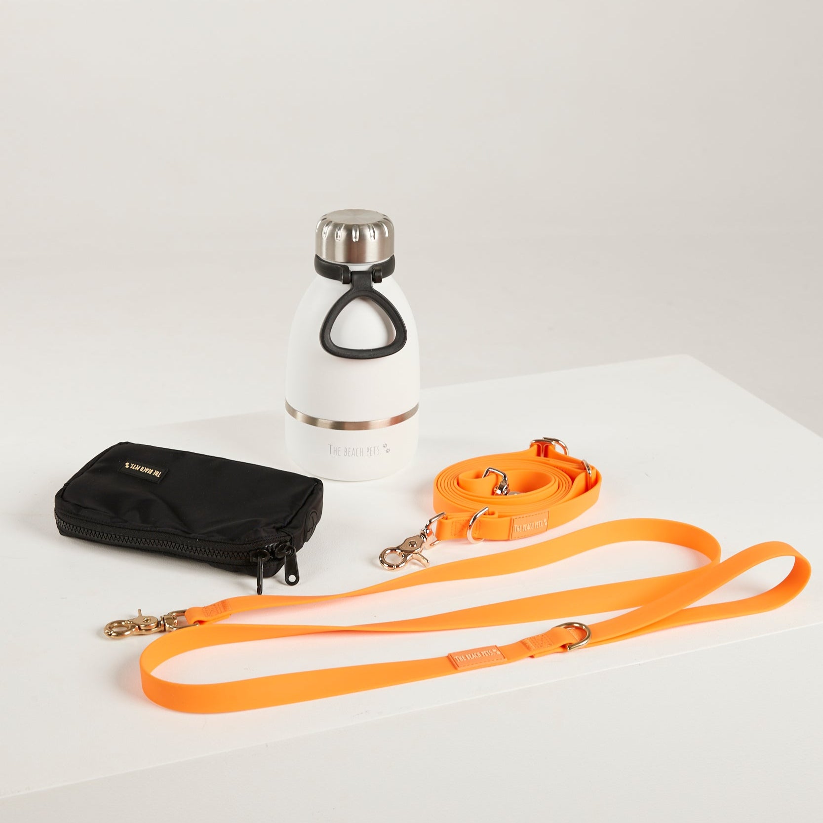 orange dog lead, hands free lead, poop bag, bottle 