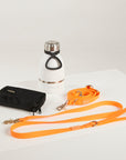 orange dog lead, hands free lead, poop bag, bottle 