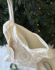 dog christmas stocking hanging on a Christmas tree
